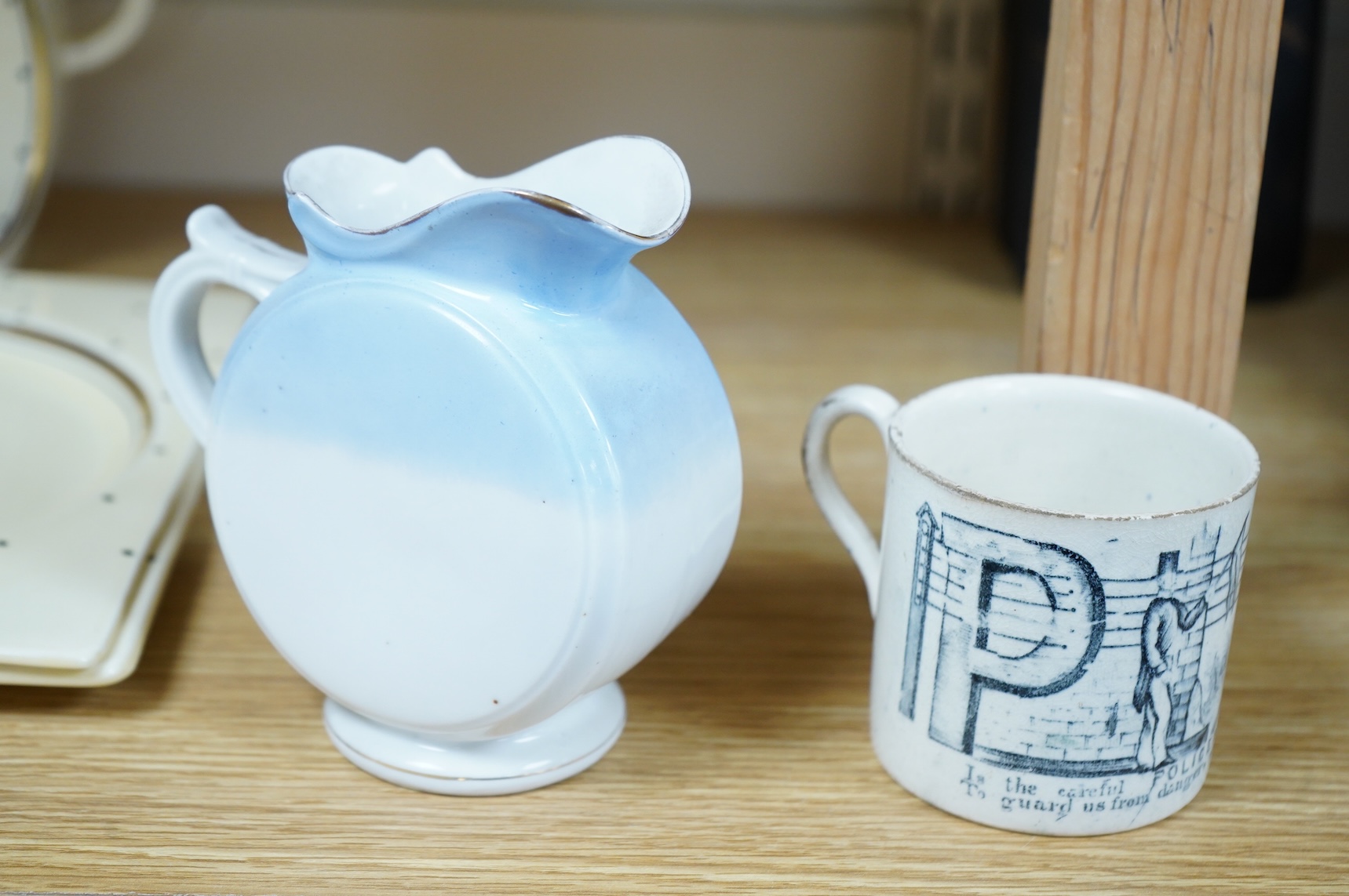 A 19th century Policeman mug and an early 20th century Brighton West Pier jug, 13cm